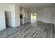 Open-concept living space featuring sleek gray floors and seamless flow into the modern kitchen at 4650 Sw 139Th Pl, Ocala, FL 34473