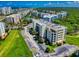 Aerial view of building featuring well-maintained landscaping, ample parking, and lush greenery, creating a welcoming atmosphere at 5300 S Atlantic Ave # 6-206, New Smyrna Beach, FL 32169