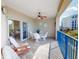 This balcony features a ceiling fan, tile flooring, and a partial view of the ocean at 5300 S Atlantic Ave # 6-206, New Smyrna Beach, FL 32169