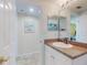 This bathroom features a shower/tub combo, a granite countertop, and access to another room at 5300 S Atlantic Ave # 6-206, New Smyrna Beach, FL 32169