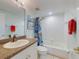 This bathroom features a shower/tub combo, a granite countertop, and a large mirror at 5300 S Atlantic Ave # 6-206, New Smyrna Beach, FL 32169