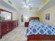 This bright bedroom features a ceiling fan, a tiled floor, a dresser, and a mirrored closet at 5300 S Atlantic Ave # 6-206, New Smyrna Beach, FL 32169