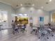A clubhouse interior featuring seating and access to the community kitchen at 5300 S Atlantic Ave # 6-206, New Smyrna Beach, FL 32169