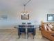 Dining area with a sleek table and comfortable seating next to the cozy living room at 5300 S Atlantic Ave # 6-206, New Smyrna Beach, FL 32169