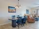 Dining room featuring a dark wood table with seating and view into the adjacent living area at 5300 S Atlantic Ave # 6-206, New Smyrna Beach, FL 32169