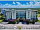 Beautiful condo building with lush surroundings and a parking area at 5300 S Atlantic Ave # 6-206, New Smyrna Beach, FL 32169