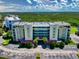Beautiful condo building with lush surroundings and a parking area at 5300 S Atlantic Ave # 6-206, New Smyrna Beach, FL 32169