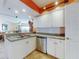 Lovely kitchen showcasing stainless steel appliances, white cabinetry, and an open layout to living space at 5300 S Atlantic Ave # 6-206, New Smyrna Beach, FL 32169