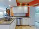 Bright kitchen showcasing stainless steel appliances, white cabinetry, and granite countertops at 5300 S Atlantic Ave # 6-206, New Smyrna Beach, FL 32169