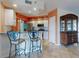 Well-lit kitchen with stainless steel appliances, counter seating, and a view of the dining area at 5300 S Atlantic Ave # 6-206, New Smyrna Beach, FL 32169