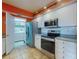 Open kitchen design with stainless steel appliances and a convenient in-unit laundry room at 5300 S Atlantic Ave # 6-206, New Smyrna Beach, FL 32169