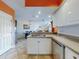 Bright kitchen showcasing stainless steel appliances, white cabinetry, and an open layout to dining area at 5300 S Atlantic Ave # 6-206, New Smyrna Beach, FL 32169