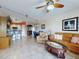 Open-concept living room with tile flooring, connecting to the dining area and kitchen at 5300 S Atlantic Ave # 6-206, New Smyrna Beach, FL 32169