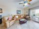 Cozy living room with leather seating, ceiling fan, and balcony access featuring beautiful outdoor views at 5300 S Atlantic Ave # 6-206, New Smyrna Beach, FL 32169