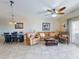 Open-concept living area with comfortable furniture, tile flooring, and natural light at 5300 S Atlantic Ave # 6-206, New Smyrna Beach, FL 32169