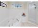 The spacious bathroom features a soaking tub and a separate shower at 5300 S Atlantic Ave # 6-206, New Smyrna Beach, FL 32169