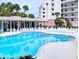 A sparkling community pool surrounded by comfortable lounge chairs at 5300 S Atlantic Ave # 6-206, New Smyrna Beach, FL 32169