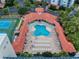Aerial view of a community pool featuring lounge chairs and lush landscaping at 5300 S Atlantic Ave # 6-206, New Smyrna Beach, FL 32169