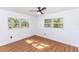 Bright bedroom featuring wood floors and natural light from two windows at 5508 Meridian Way, Orlando, FL 32808