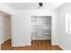 Bedroom with wood-look floors and a closet with built-in shelving at 5508 Meridian Way, Orlando, FL 32808