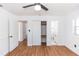 Bright bedroom features wood floors, ceiling fan, closet, and an en-suite bathroom at 5508 Meridian Way, Orlando, FL 32808