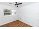 Bright bedroom with wood-style flooring, a ceiling fan, and two windows at 5508 Meridian Way, Orlando, FL 32808