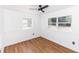 Cozy bedroom featuring wood-look floors, a ceiling fan, and natural light at 5508 Meridian Way, Orlando, FL 32808