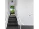 A view of the home's entrance, with a dark stairway leading up to the front door and a clean, bright white exterior at 5508 Meridian Way, Orlando, FL 32808