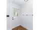 Bright entryway featuring a white door with glass panels and modern decor at 5508 Meridian Way, Orlando, FL 32808