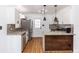 Kitchen features white cabinets, granite countertops, and stainless steel appliances at 5508 Meridian Way, Orlando, FL 32808