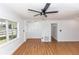Open-concept living room with wood floors and bright white walls at 5508 Meridian Way, Orlando, FL 32808