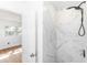 Walk-in shower with marble-style tile and a rainfall shower head at 5508 Meridian Way, Orlando, FL 32808
