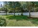 Lush backyard featuring mature trees and a pristine white fence at 619 Meadow Sage Dr, Deland, FL 32724