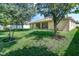 Spacious backyard features lush greenery and a screened-in patio at 619 Meadow Sage Dr, Deland, FL 32724