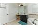 Bright bathroom features a makeup vanity, a soaking tub, and dark vanity with a light countertop and blue accessories at 619 Meadow Sage Dr, Deland, FL 32724