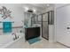 Bright bathroom features a soaking tub, walk-in shower with black trim, and a dark vanity with a light countertop at 619 Meadow Sage Dr, Deland, FL 32724