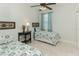 Bedroom with neutral tiled floors, two twin beds, matching patterned bedding, and blue curtains at 619 Meadow Sage Dr, Deland, FL 32724