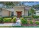 Inviting front entrance with a well-manicured lawn and decorative shrubs at 619 Meadow Sage Dr, Deland, FL 32724
