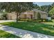 Charming single-story home featuring a well-manicured lawn and a two-car garage at 619 Meadow Sage Dr, Deland, FL 32724