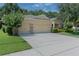Home exterior showing a spacious three car garage with a large driveway at 619 Meadow Sage Dr, Deland, FL 32724