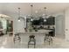 Open kitchen with a large island featuring granite countertops and seating at 619 Meadow Sage Dr, Deland, FL 32724