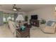 Comfortable living room with tile floors, a ceiling fan, and bright windows at 619 Meadow Sage Dr, Deland, FL 32724