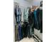 Organized walk-in closet with hanging clothes, shelving, and a shoe rack for optimal storage and convenience at 619 Meadow Sage Dr, Deland, FL 32724