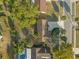 Birds eye view of home featuring lush greenery, landscaping, a pool, and a long driveway at 6209 Beaumont Ave, Orlando, FL 32808