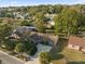 Beautiful aerial view of home with palm trees, long driveway, and lush landscaping at 6209 Beaumont Ave, Orlando, FL 32808