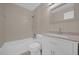 This bathroom features tiled walls, vanity with storage, and bathtub with shower head at 6209 Beaumont Ave, Orlando, FL 32808