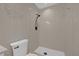 This bathroom features tiled walls, white toilet, and shower with matte black shower head at 6209 Beaumont Ave, Orlando, FL 32808