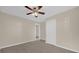 Bedroom with neutral walls, wood-look floor, ceiling fan, and closet at 6209 Beaumont Ave, Orlando, FL 32808