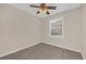 This bedroom features light beige walls, a ceiling fan, and gray wood-look flooring at 6209 Beaumont Ave, Orlando, FL 32808
