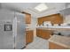 Bright kitchen featuring wood cabinets, stone countertops, backsplash and stainless steel appliances at 6209 Beaumont Ave, Orlando, FL 32808